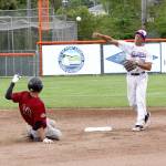 Dave Logan/for Peninsula Daily News Port Angeles Jason Dicochea makes a throw to first base to complete a double play after forcing Corvallis Cameron Haskell at second Wednesday at Civic Field.