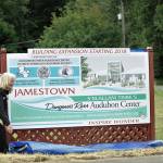 Annette Hanson, capital campaign committee chair for the expansion of the Dungeness River Audubon Center, and Ron Allen, tribal chairman of the Jamestown SKlallam Tribe, reveal a new sign at the entrance to the Railroad Bridge Park. (Matthew Nash/Olympic Peninsula News Group)