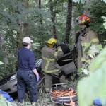 Forks and Beaver fire department personnel and Forks medics prepare to move the wreck victim from his vehicle. He was transported to Forks Community Hospital. (Lonnie Archibald/for Peninsula Daily News)