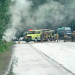 Emergency vehicles block the Trans-Canada Highway east of Chilliwack, B.C., Tuesday afternoon after the Port Angeles Lefties rescued a woman from her burning car on their way to their game in Kelowna, B.C.