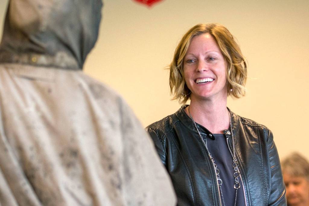 Amy Miller talks with a man at the Salvation Army about services that may be available. (Jesse Major/Peninsula Daily News)