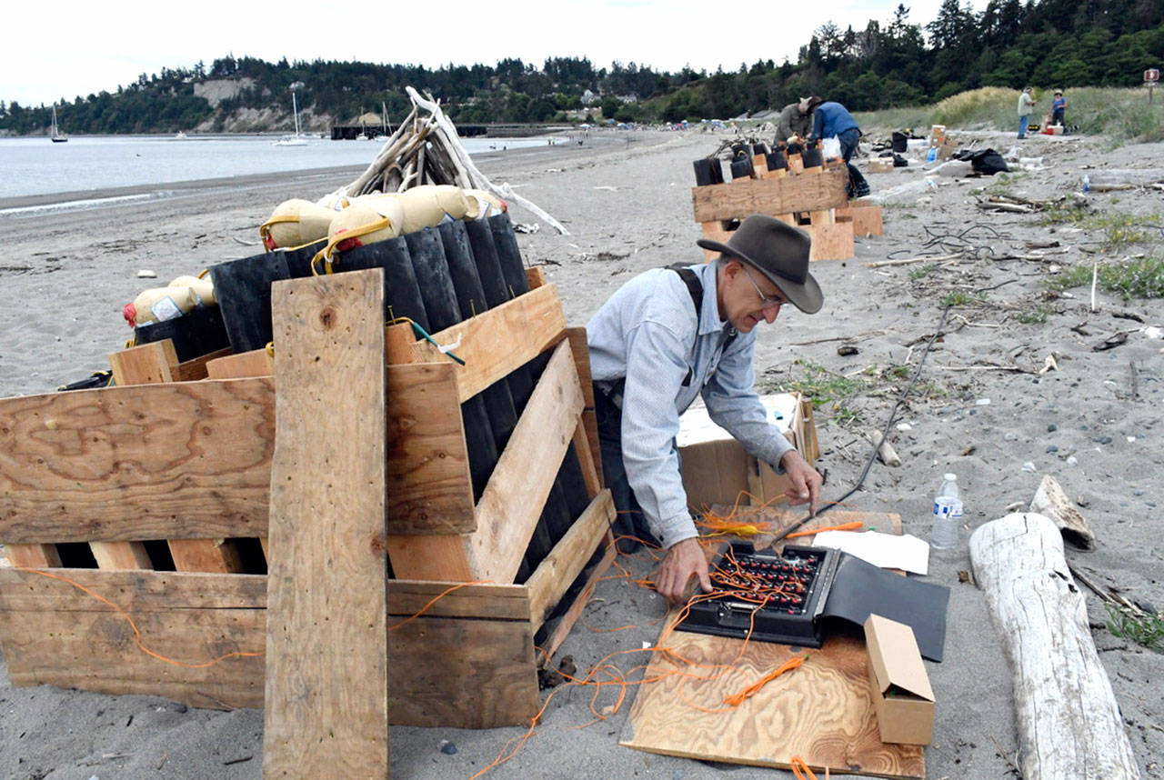 Pyrotechnician David Chuljian sets firing mechanisms with his team as they prep on Wednesday afternoon for the fireworks display finale of the Old School 4th of July at Fort Worden. By his count, Chuljian said there are 232 large and medium-sized mortars and several smaller ones worth 15 minutes of booms and flash. Hes been lighting off fireworks, legally, for 35 years. (Jeannie McMacken/Peninsula Daily News)