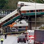 In this Dec. 18, 2017, file photo, cars from an Amtrak train lie spilled onto Interstate 5 below alongside smashed vehicles as some train cars remain on the tracks in DuPont. (Elaine Thompson/The Associated Press)