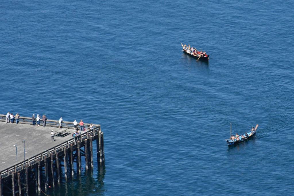 Canoe teams make their way past the Port Townsend Marine Science Center dock on their way to a landing at the Fort Worden beach Monday. (Jeannie McMacken/Peninsula Daily News)