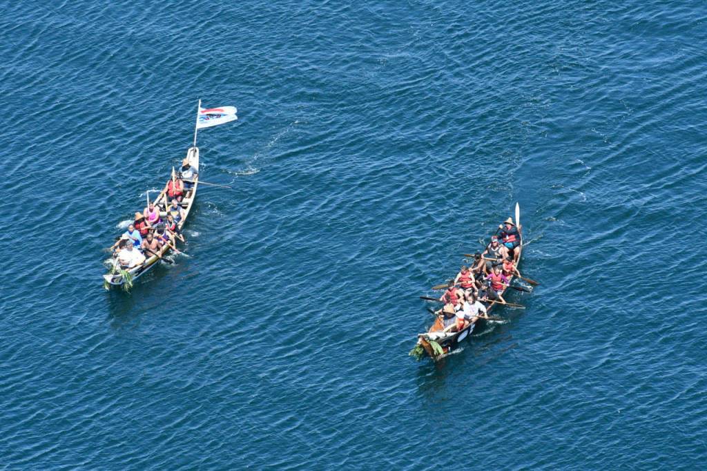 A pair of canoes approach Fort Worden on Monday. (Jeannie McMacken/Peninsula Daily News)