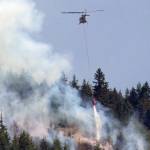 At least one helicopter assisted with water drops on the Blyn fire on Friday. (Robert Steelquist)
