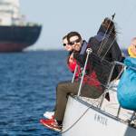 Crew members of the Wild Thing hang over the side of their boat during the Port Angeles Yacht Clubs beer can races in the Port Angeles Harbor on Friday. (Jesse Major/Peninsula Daily News)