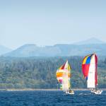 Two sailboats participating in the Port Angeles Yacht Clubs beer can races compete in the Port Angeles Harbor on Friday. (Jesse Major/Peninsula Daily News)