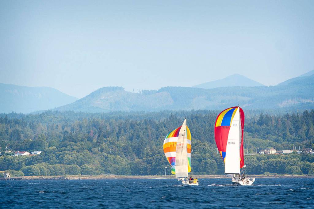 Two sailboats participating in the Port Angeles Yacht Clubs beer can races compete in the Port Angeles Harbor on Friday. (Jesse Major/Peninsula Daily News)