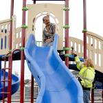 Keith Thorpe/Peninsula Daily News Port Angeles Parks Department worker Brooke Keohokaloke, right, hands a drill to coworker Leon Leonard as the pair assemble new playground equipment at Georgiana Park in Port Angeles on Tuesday. The equipment was the result of $148,000 in funding and in-kind labor to buy new playground pieces and a wheelchair-friendly surface for the play area, located a block from Olympic Medical Center. Keohokaloke said the goal was to have the equipment finished and the playground open by the end of summer.