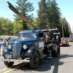 A 1937 logging truck driven by Joyce-area logger John Singhose, accompanied by his wife, Lelah, makes its way down the Grand Parade route during Saturdays Joyce Daze Wild Blackberry Festival for the 36th consecutive year, making it the only vehicle to participate in every Joyce Daze parade since the festivals inception. The Singhoses were this years parade grand marshals. (Keith Thorpe/Peninsula Daily News)