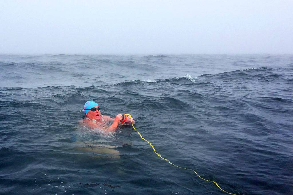 Michelle Macy, a marathon swimmer from Portland, Ore., refuels as she makes her way across the Strait of Juan de Fuca on Monday. (Andrew Malinak/NOWSA)