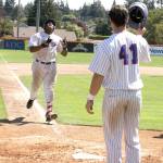 Dave Logan/for Peninsula Daily News Port Angeles Ron Brown, left, points to the heavens as teammate Trey Morgan waits to congratulate the Houston slugger on his sixth home run of the season.
