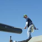 John White of Freeland works to paint the Big Guns at Fort Casey. It was a good day to paint, with the sunshine and fresh air, he said. (Maria Matson/Whidbey News Group)