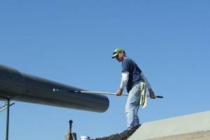 John White of Freeland works to paint the Big Guns at Fort Casey. It was a good day to paint, with the sunshine and fresh air, he said. (Maria Matson/Whidbey News Group)