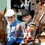 Lillian Bond, 9, and her horse, Mac, left, and Kennady Gilbertson, 11, and her horse, Copper, sit outside a horse barn at the Clallam County Fair on Thursday. The girls, both of Port Angeles and members of the Pony Express 4-H Club, were waiting for their turn before the judges in the show ring. (Keith Thorpe/Peninsula Daily News)
