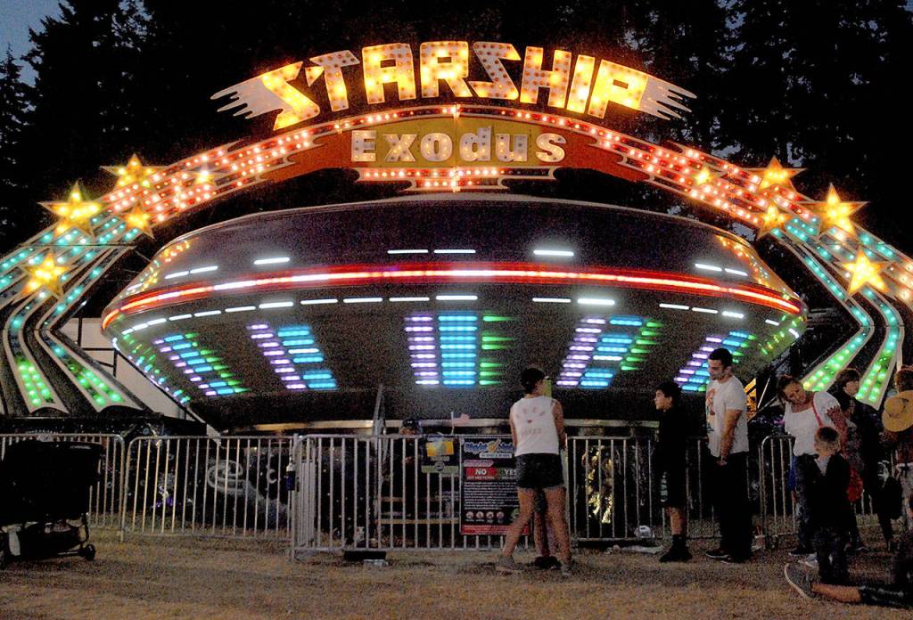 The spinning Starship Exodus ride draws carnival-goes on Friday night at the Clallam County Fair. (Keith Thorpe/Peninsula Daily News)