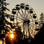 The sun sets behind the Ferris wheel at the county fair carnival on Friday evening. (Keith Thorpe/Peninsula Daily News)