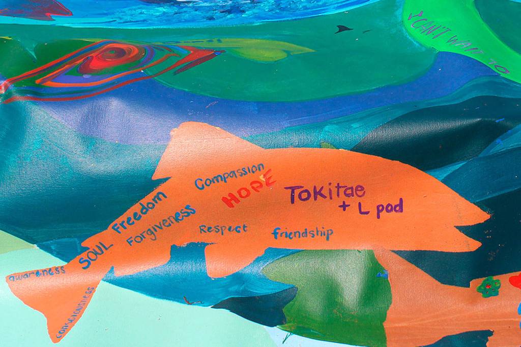 A banner at the Orca Networks Bring Tokitae Home event on Aug. 8 was painted by the Lummi Nation in honor of the orcas captured in Penn Cove in the 1960s and 70s. Tokitae/Lolita, an entertainer at the Miami Seaquarium, is the last surviving orca captured from her pod. (Patricia Guthrie/Whidbey News-Times)