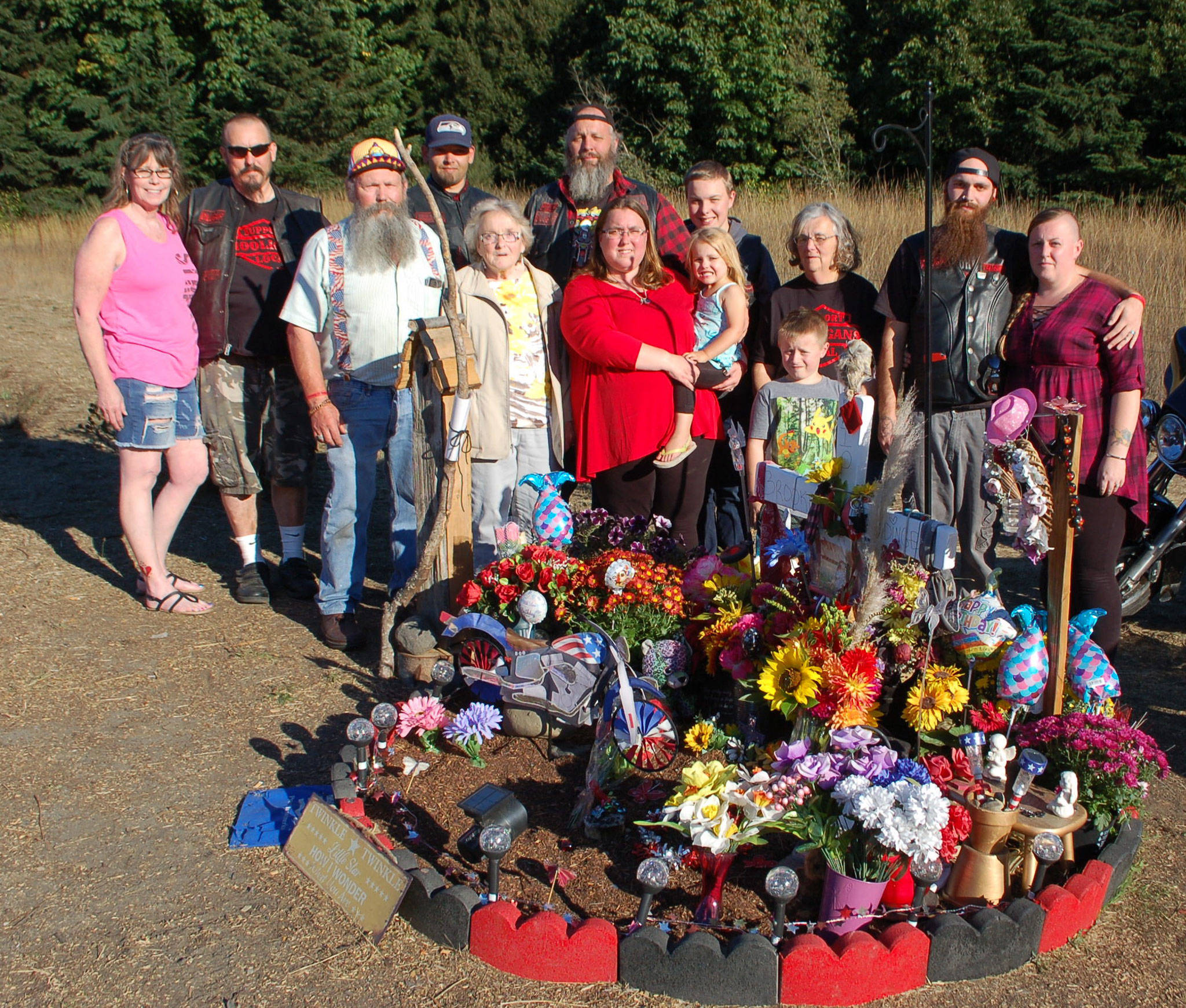 Brooke Bedingers family stands at her memorial on the side of U.S. Highway 101. (Erin Hawkins/Olympic Peninsula News Group)
