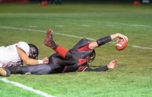 Steve Mullensky/for Peninsula Daily News                                Port Townsends Dylan Tracer tries to gain extra inches after being tackled by Coupvilles Sean Toomey-Stout during first half action of a game played in Memorial Field in Port Townsend on Friday.