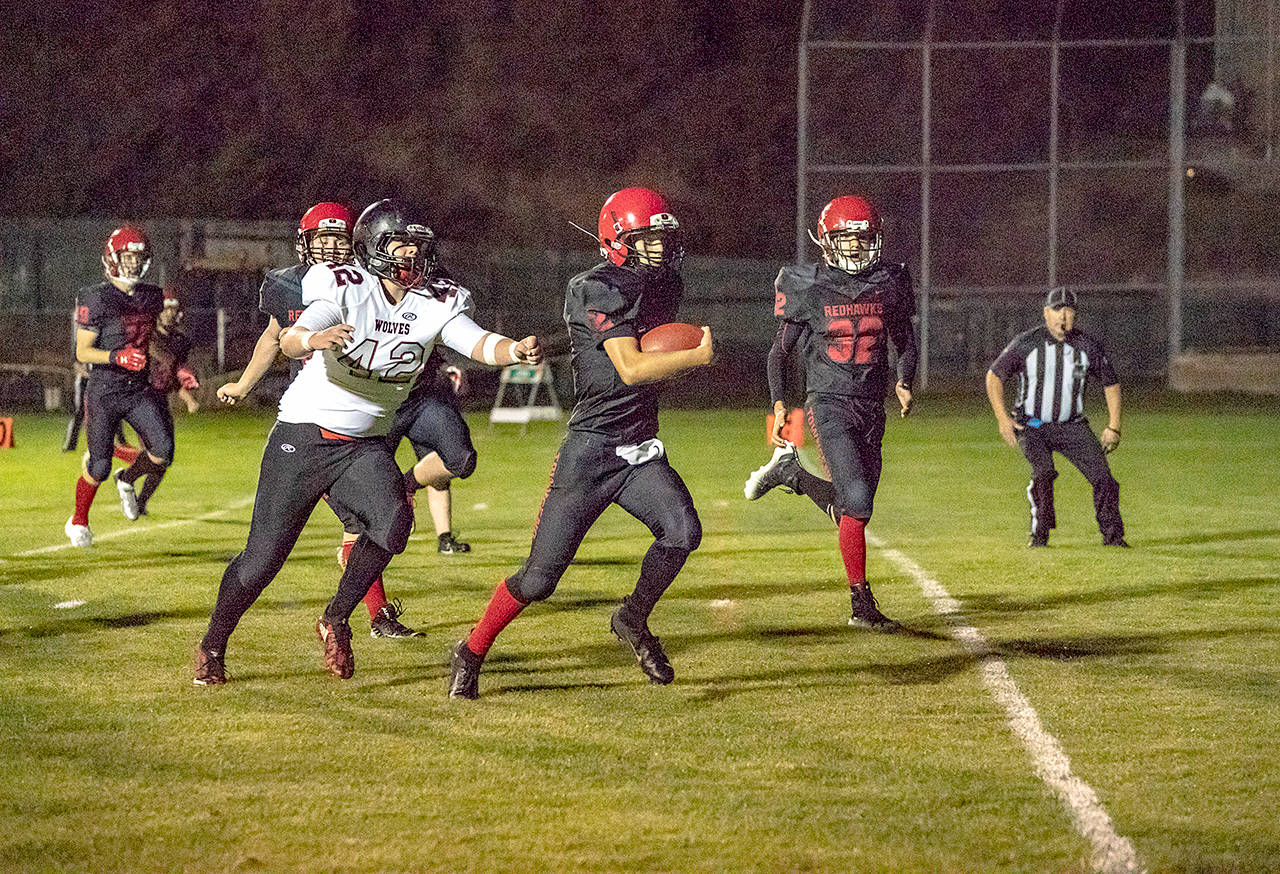 Steve Mullensky/for Peninsula Daily News Port Townsend freshman quarterback Tanner Woodley scampers for a touchdown against the Coupeville Wolves at Memorial Field in Port Townsend.