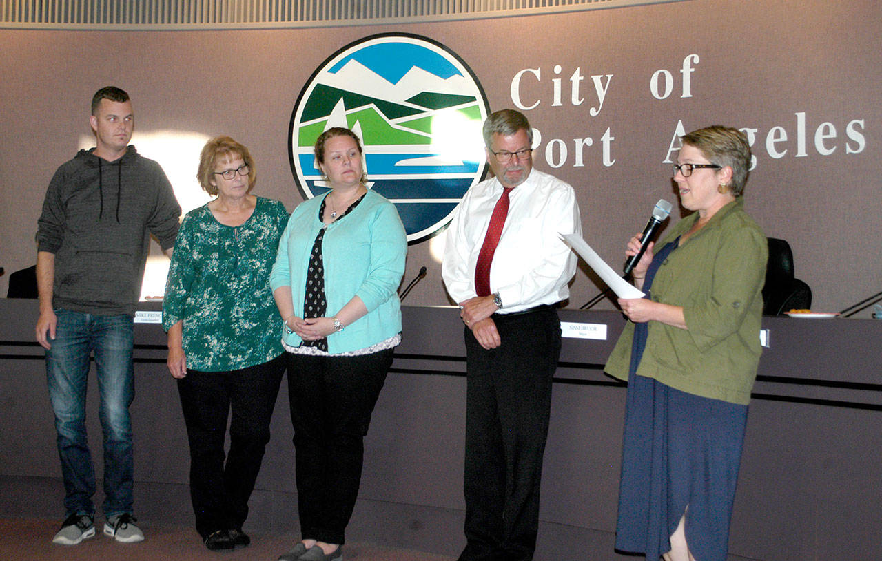 Retired Port Angeles City Manager Dan McKeen, second from right, receives a proclamation from Deputy Mayor Kate Dexter, right, on Tuesday in recognition of his 33 years of service to the city. He is flanked by his son, Joel, his wife, Jan, and daughter, Teresa. Dan McKeen, 62, became Port Angeles Fire Chief in 2000 and City Manager in 2012. His last day working for the city was Wednesday. Im looking forward to spending more time with my family, and Ive been really blessed in my career, he said. Nathan West, former Port Angeles Community and Economic director and acting city manager, became full-time city manager today. (Rob Ollikainen/Peninsula Daily News)