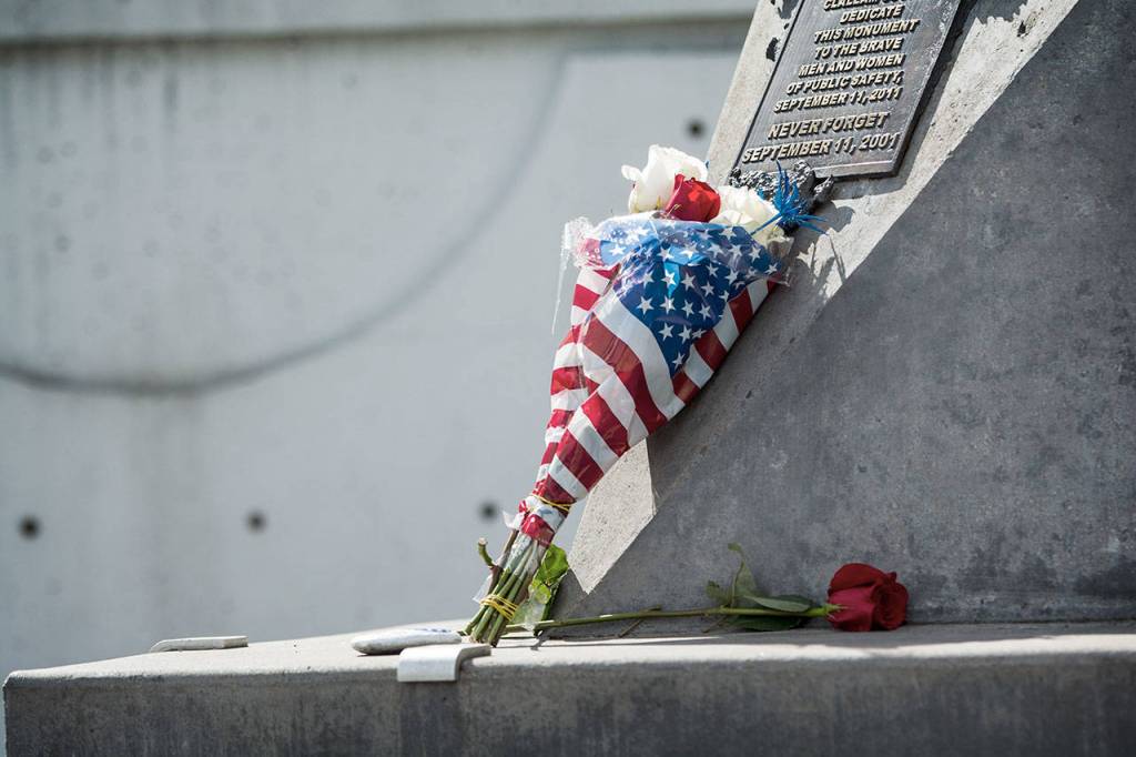 Flowers rest against the I-beam at the 9/11 Memorial Waterfront Park in Port Angeles on Tuesday. (Jesse Major/Peninsula Daily News)