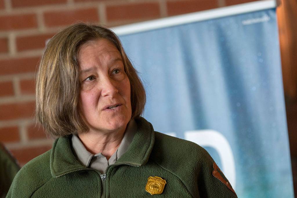 Olympic National Park Deputy Superintendent Lee Taylor tells U.S. Reps. Derek Kilmer and Steve Womack about issues that affect Olympic National Park. (Jesse Major/Peninsula Daily News)