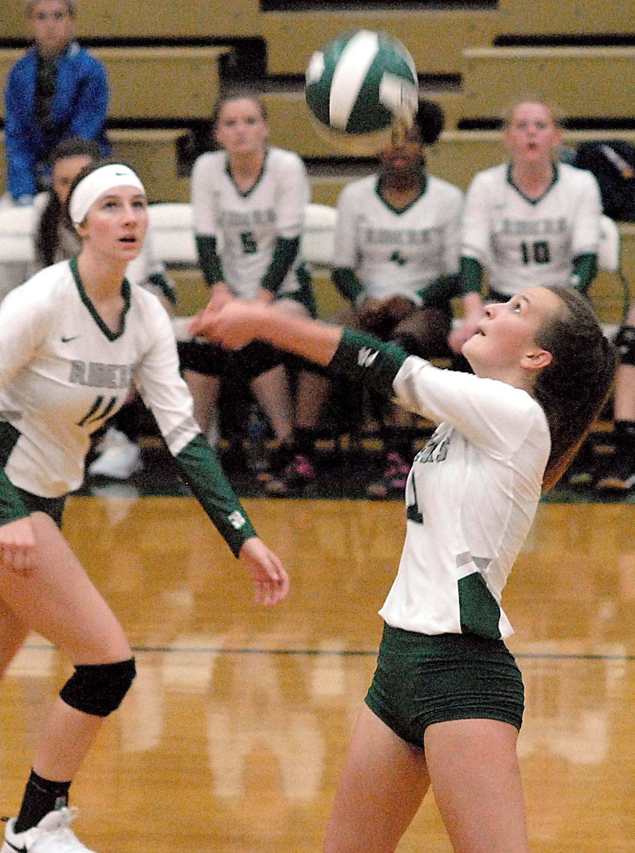 Keith Thorpe/Peninsula Daily News Port Angeles Nacia Bohman goes for the ball as teammate Ava Brenkman, left, looks on during the first game of their Tuesday night match against North Mason at Port Angeles High School.
