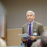 Olympic Medical Center CEO Eric Lewis told about 50 people Tuesday evening of a proposal that would cut Medicare reimbursements for off-site clinics by 60 percent. (Jesse Major/Peninsula Daily News)