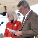 The Rev. Tom Steffen of the First United Methodist Church in Port Angeles reads a prayer during a dedication ceremony on Wednesday evening for suicide-proof fencing on the two Eighth Street bridges. Accompanying him was City Council Member Cherie Kidd. (Keith Thorpe/Peninsula Daily News)
