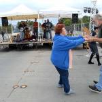 Clair and Bill Kirkman of Port Angeles dance to the music of The Weavils on the Eighth Street bridge over Valley Creek on Wednesday evening, closing out the 2018 Concerts on the Pier summer music series. (Keith Thorpe/Peninsula Daily News)