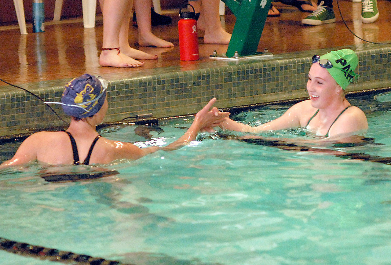 Keith Thorpe/Peninsula Daily News Port Angeles Nadia Cole, right, is congratulated by Sequims Mia Coffman after Cole took first in the 500-yard freestyle event with an unofficial time of 5:37.81 on Thursday at William Shore Memorial Pool in Port Angeles.