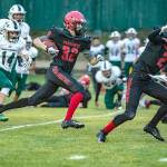 <strong>Steve Mullensky</strong>/for Peninsula Daily News                                Port Townsends Emil Makkula picks up protection from Tanner Woodley before running for a touchdown Friday.