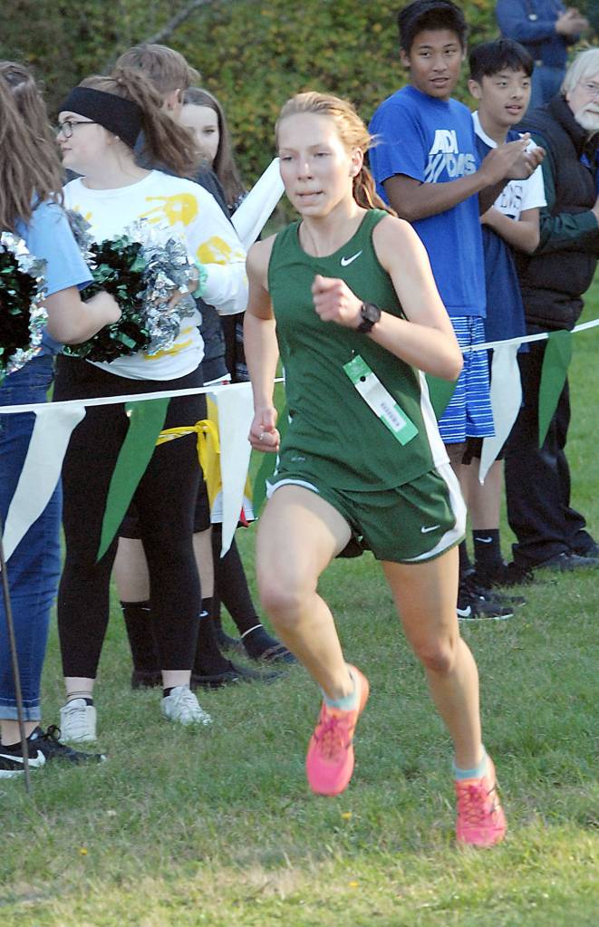 Keith Thorpe/Peninsula Daily News Lauren Larson of Port Angeles finishes far ahead of the next closest competitor during the girls cross-country race on Wednesday on her home course in Lincoln Park.