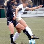 Keith Thorpe/Peninsula Daily News Skagit Valleys Morgan Jones, left and Peninsulas Halle Watson get tangled near midfield on Wednesday at Wally Sigmar Field in Port Angeles.