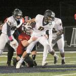 Forks Gabriel Terrones (8) escapes the grasp of Teninos Robby Marti Friday night in Forks during Homecoming. Also in on the action for Forks are Colby Demorest (63) and Eden Cisneros (56). (Lonnie Archibald/for Peninsula Daily News).