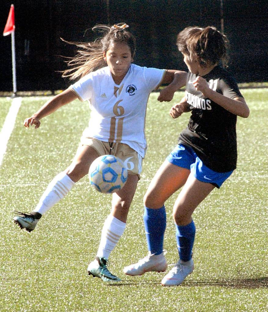 Keith Thorpe/Peninsula Daily News Peninsulas Cindy Vasquez, left, dribbles past Edmonds Jazmin Nunez in the first half on Wednesday.
