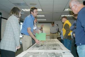 <strong>Rob Ollikainen</strong>/Peninsula Daily News                                Port Angeles civil engineer Jonathan Boehme, second from left, explains preliminary designs for safety improvements to Lincoln Street at an open house in the Vern Burton Community Center. Planned improvements include bike lanes, extended curbs and a new traffic signal at Third Street.