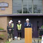 Sequim Schools Superintendent, Gary Neal, center, speaks during a groundbreaking ceremony at the Sequim Community School in May, with school board director Heather Short, left, and project managers of Vanir Construction Management, Inc. (Erin Hawkins/Olympic Peninsula News Group)