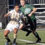 Keith Thorpe/Peninsula Daily News Peninsulas Pablo Medina is challenged by Shorelines Niklas Axelson on Saturday in Port Angeles.