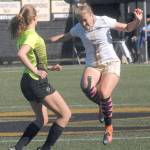 Keith Thorpe/Peninsula Daily News Peninsulas Emilee Greve, right, takes the header in front of Shorelines Courtney Wagner on Saturday at Wally Sigmar Field in Port Angeles.