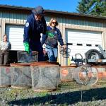 Volunteers and staff with the Dungeness Wildlife Refuge, from left, Steve Muller, Juliana Merluccio, Bob Anundson and Lea Sollmann clean traps on Thursday after months of efforts to reduce the number of European green crab on the Dungeness Spit. (Matthew Nash/Olympic Peninsula News Group)