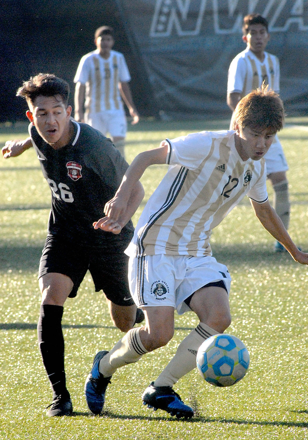 Keith Thorpe/Peninsula Daily News Peninsulas Hide Inoue, front, cuts off Everetts Oscar Rodriguez in Wednesdays match in Port Angeles.