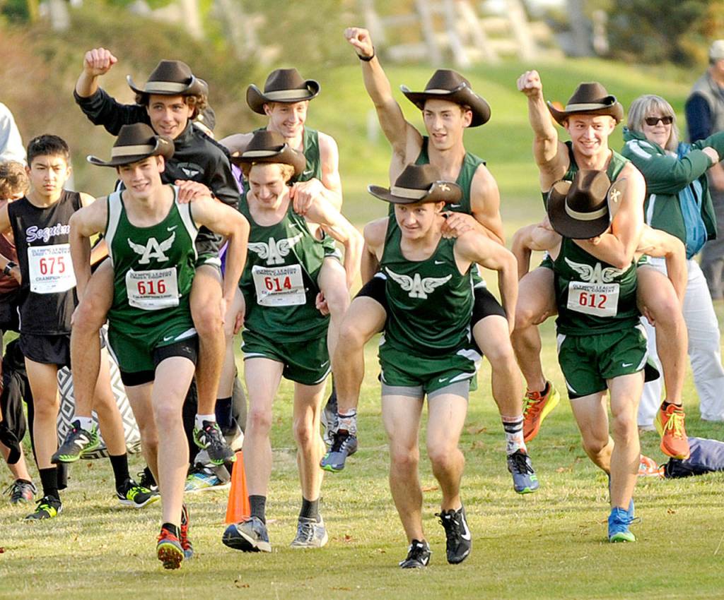 The Port Angeles boys cross-country team celebrates at the Olympic League championships at Port Townsend on Thursday. (By Michael Dashiell/Olympic Peninsula News Group)