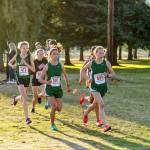 Port Angeles Lauren Larson, 603, has a slight edge on teammate Kynzie DeLeon, 597, at Port Townsend Golf Course during the Olympic League Cross Country Championship on Thursday. Larson pulled away and went on to win the girls varsity event while DeLeon came in fourth. Also in the photo is Sequims Riley Pyeatt, in black, who finished fifth. (Steve Mullensky/for Peninsula Daily News)