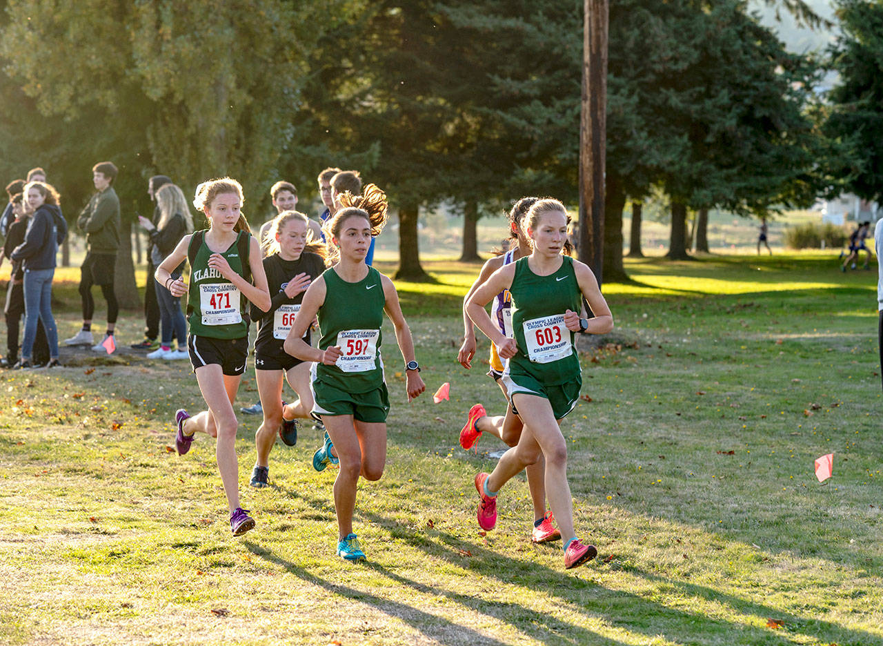 Port Angeles Lauren Larson, 603, has a slight edge on teammate Kynzie DeLeon, 597, at Port Townsend Golf Course during the Olympic League Cross Country Championship on Thursday. Larson pulled away and went on to win the girls varsity event while DeLeon came in fourth. Also in the photo is Sequims Riley Pyeatt, in black, who finished fifth. (Steve Mullensky/for Peninsula Daily News)