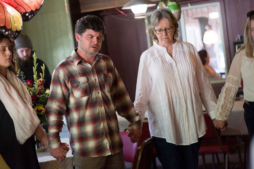Tim Pinson the new owner of Grannys Cafe, leads a prayer at the restaurant on Sunday. (Jesse Major/Peninsula Daily News) (Jesse Major/Peninsula Daily News)