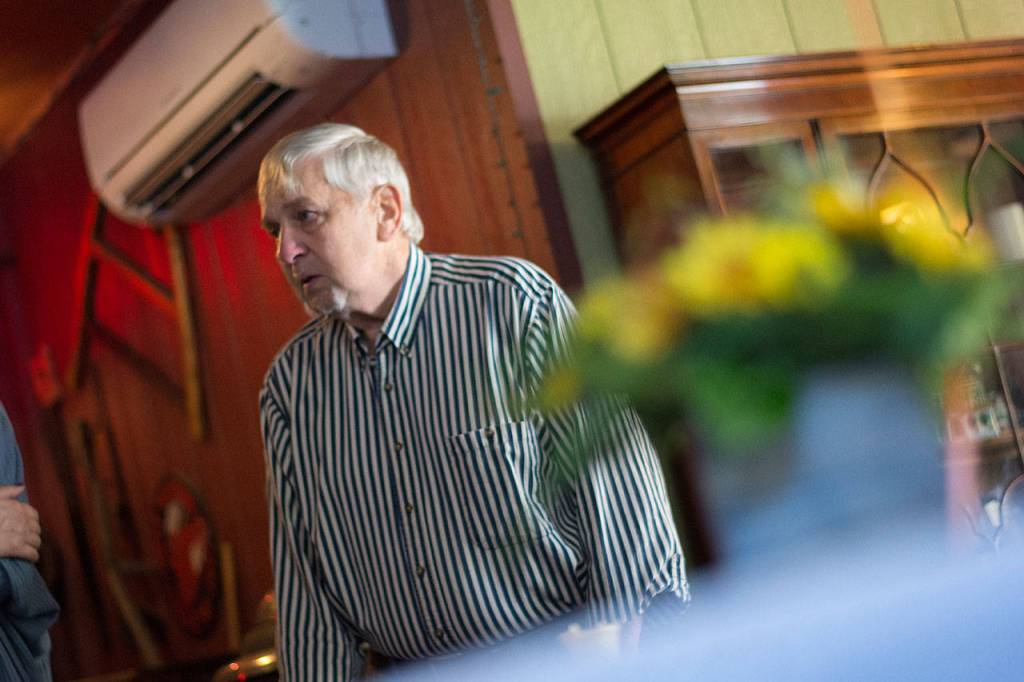 Loren Luce, who helped his father Schuler Luce build the motel at Grannys Cafe, tells the restaurants new owner that he appreciates that his family is Christian. (Jesse Major/Peninsula Daily News)